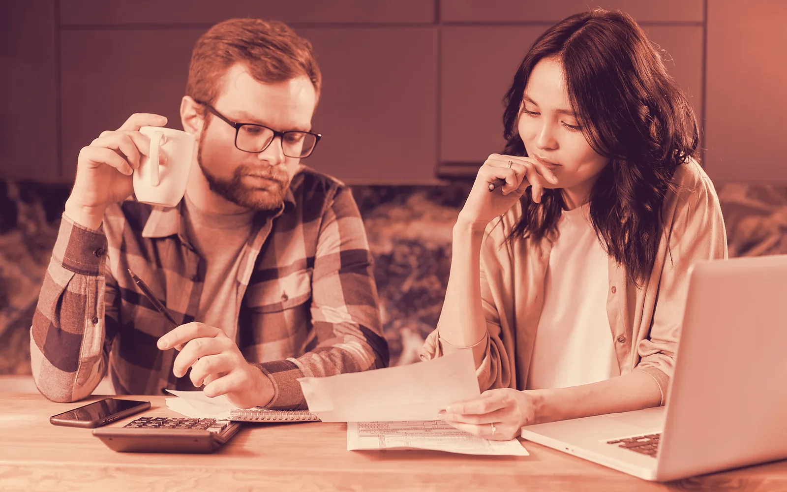 Couple reviewing documents at a kitchen table