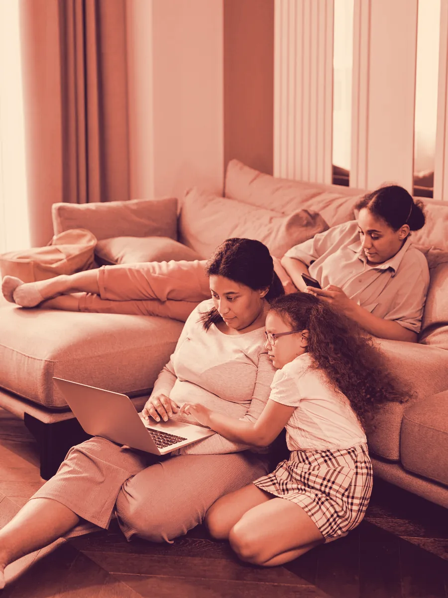 Adult daughter and her mother looking at a laptop together